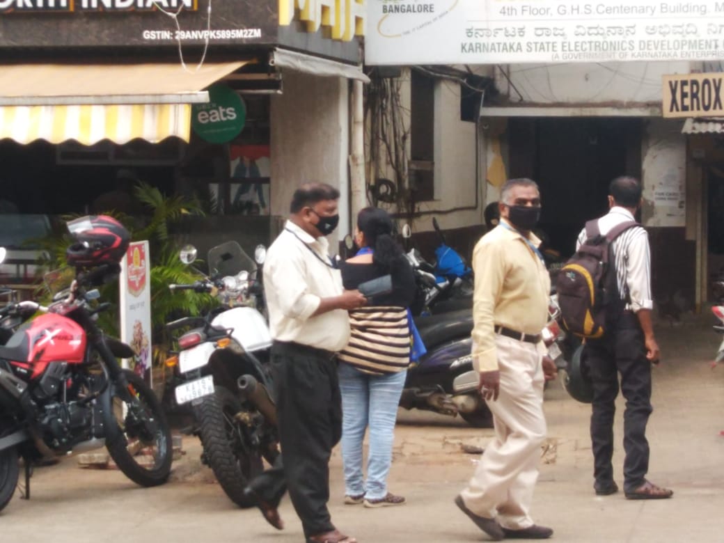 Mangaluru City Corporation officials asking the shops to down their shutters in Mangaluru